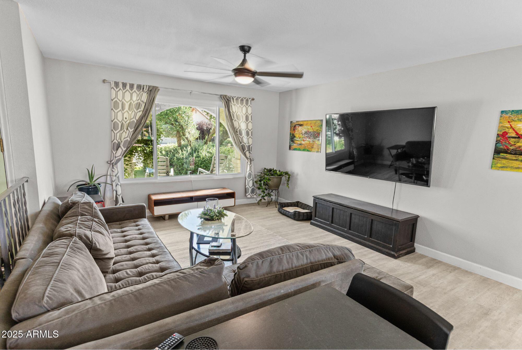 1210 East Harbor View Drive Tempe, AZ 85283 - Photo 13 of 68 a living room with furniture and a flat screen tv