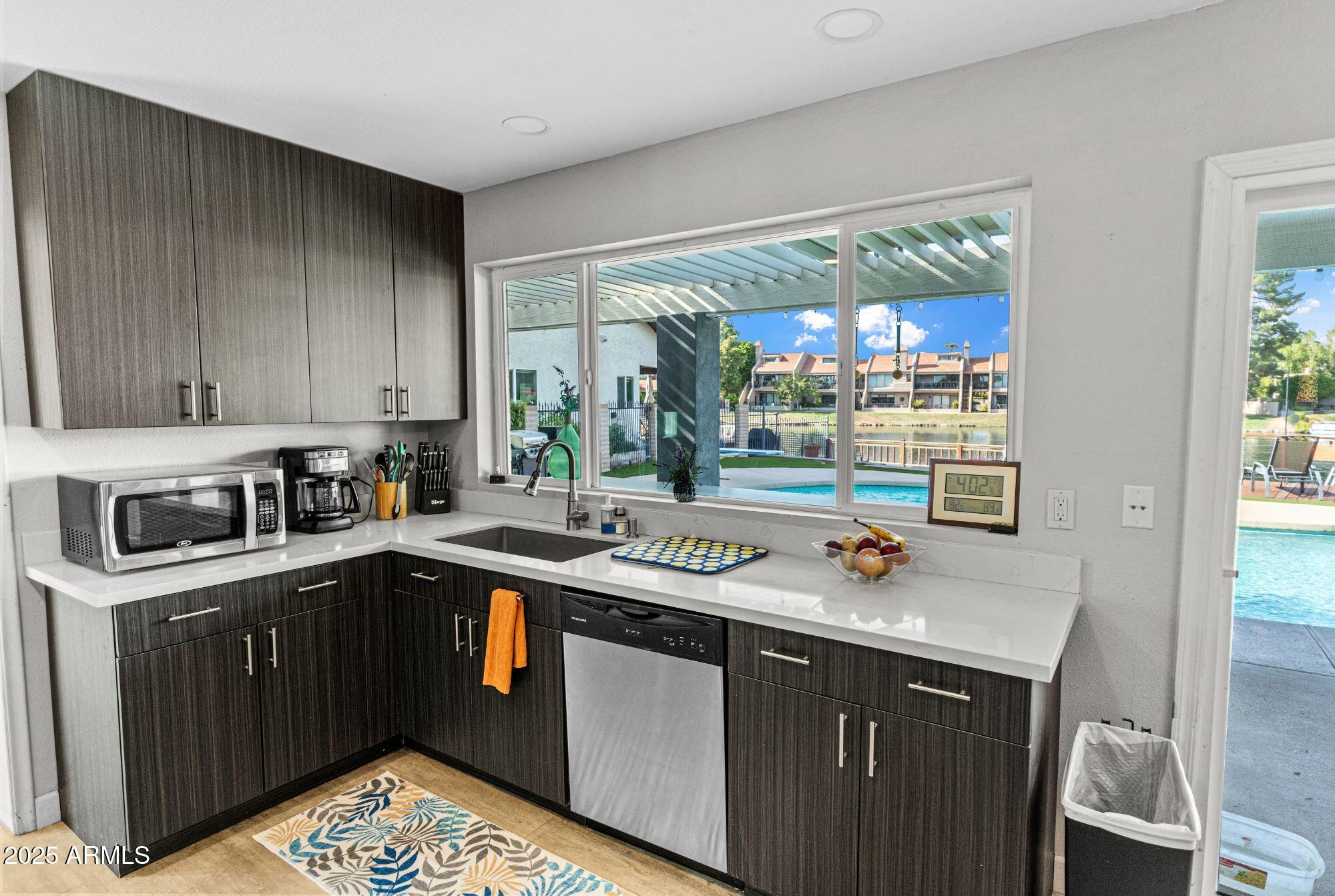 1210 East Harbor View Drive Tempe, AZ 85283 - Photo 18 of 68 a kitchen with a sink stove and cabinets