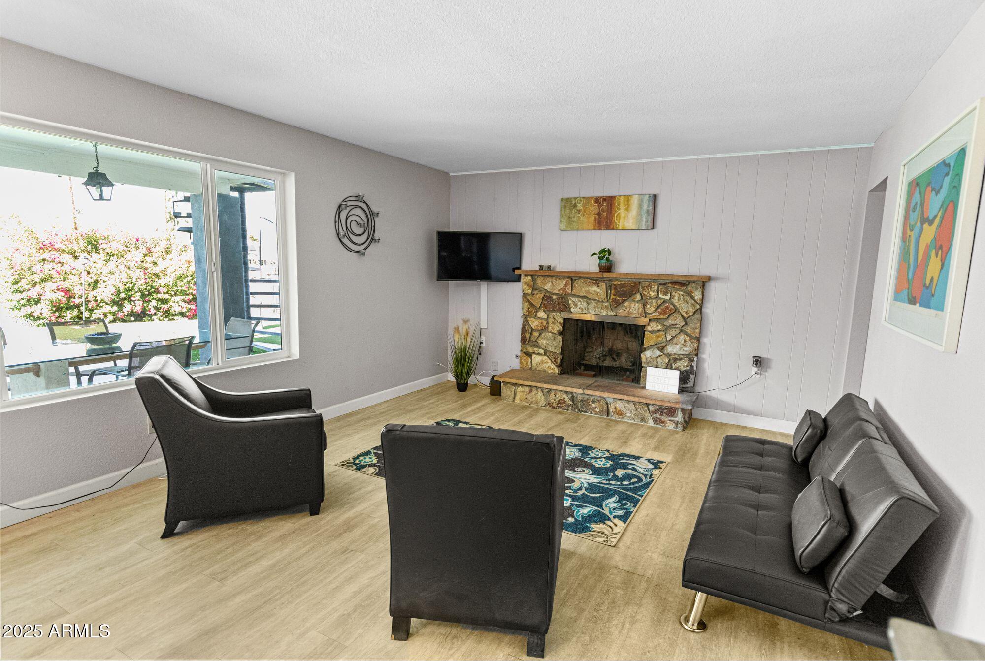 1210 East Harbor View Drive Tempe, AZ 85283 - Photo 25 of 68 a living room with furniture and a fireplace