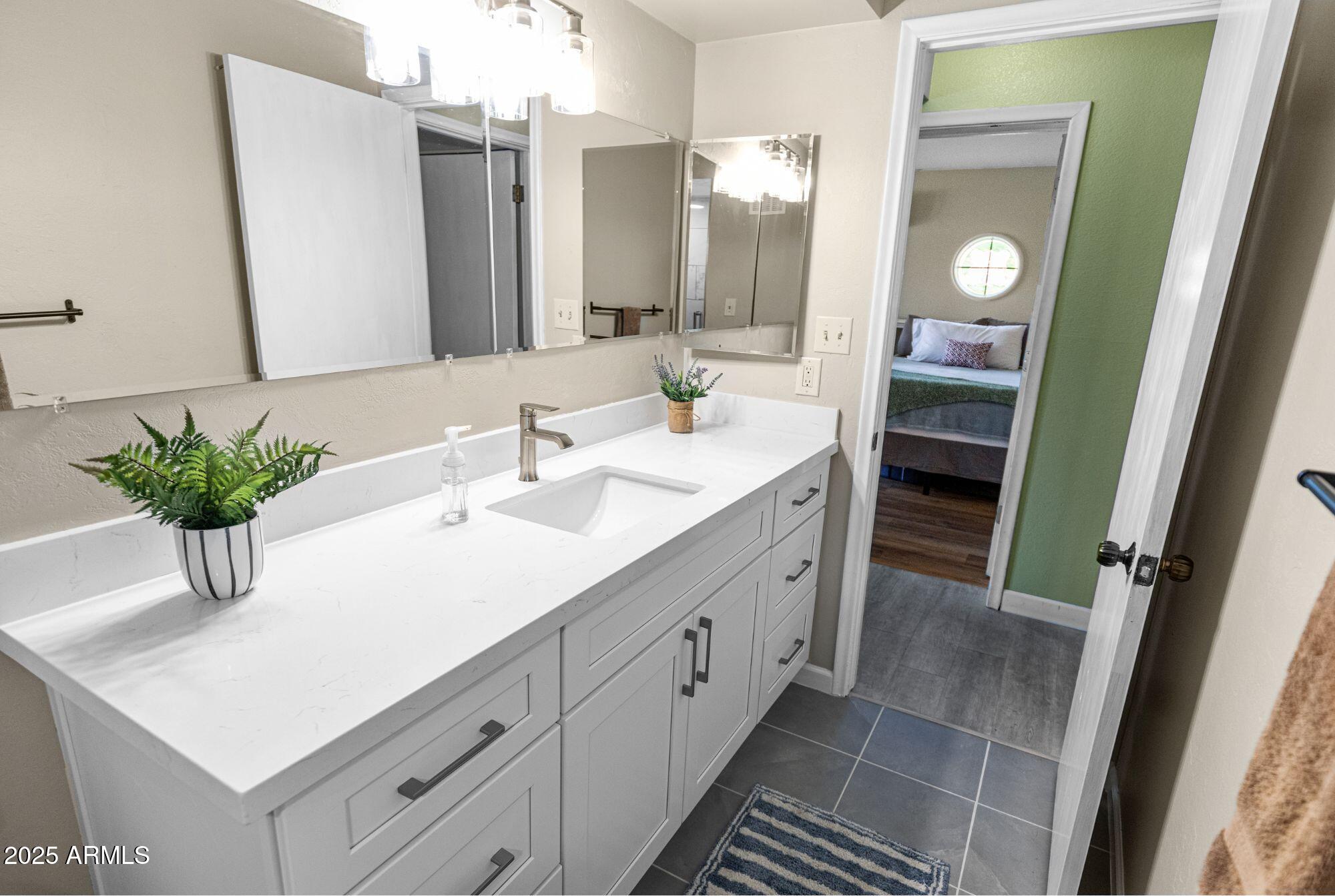 1210 East Harbor View Drive Tempe, AZ 85283 - Photo 30 of 68 a bathroom with a sink vanity and a mirror