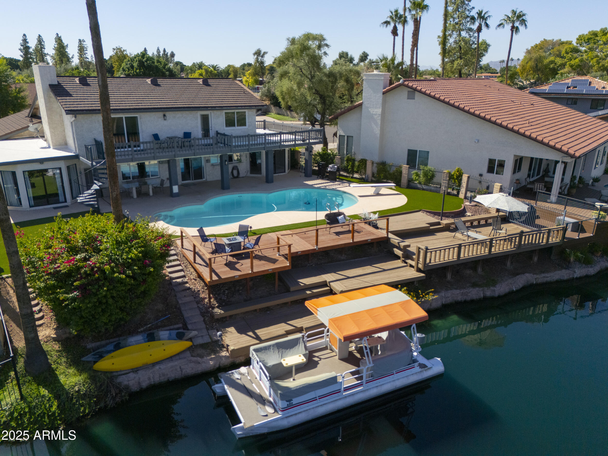 1210 East Harbor View Drive Tempe, AZ 85283 - Photo 4 of 68 a swimming pool view with a couple of cars parked in front of a house