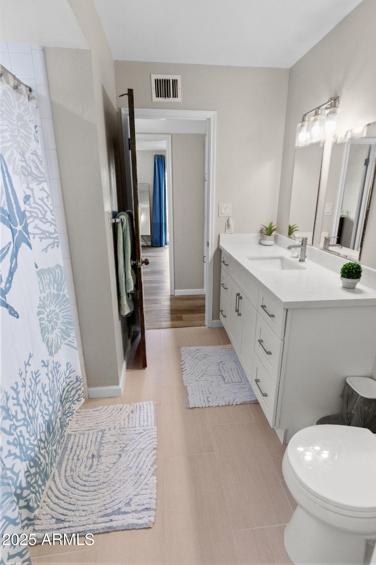 1210 East Harbor View Drive Tempe, AZ 85283 - Photo 42 of 68 a bathroom with a double vanity sink toilet and mirror
