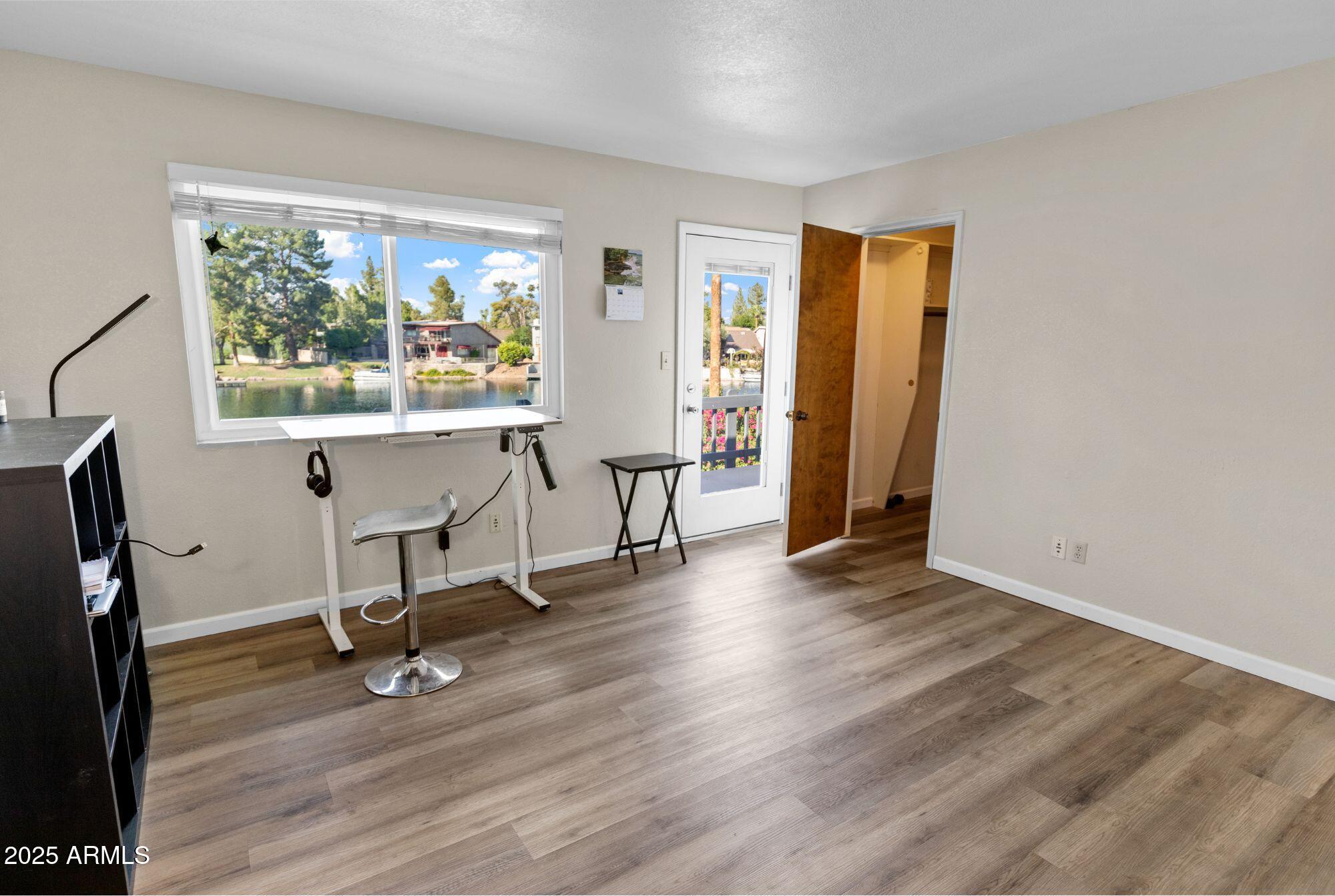 1210 East Harbor View Drive Tempe, AZ 85283 - Photo 44 of 68 a view of a workspace with wooden floor and a window