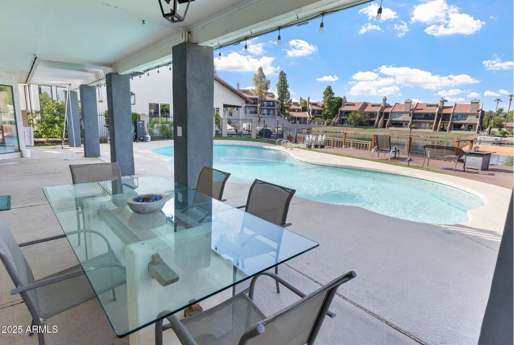 1210 East Harbor View Drive Tempe, AZ 85283 - Photo 51 of 68 a view of a dining room with furniture and a floor to ceiling window