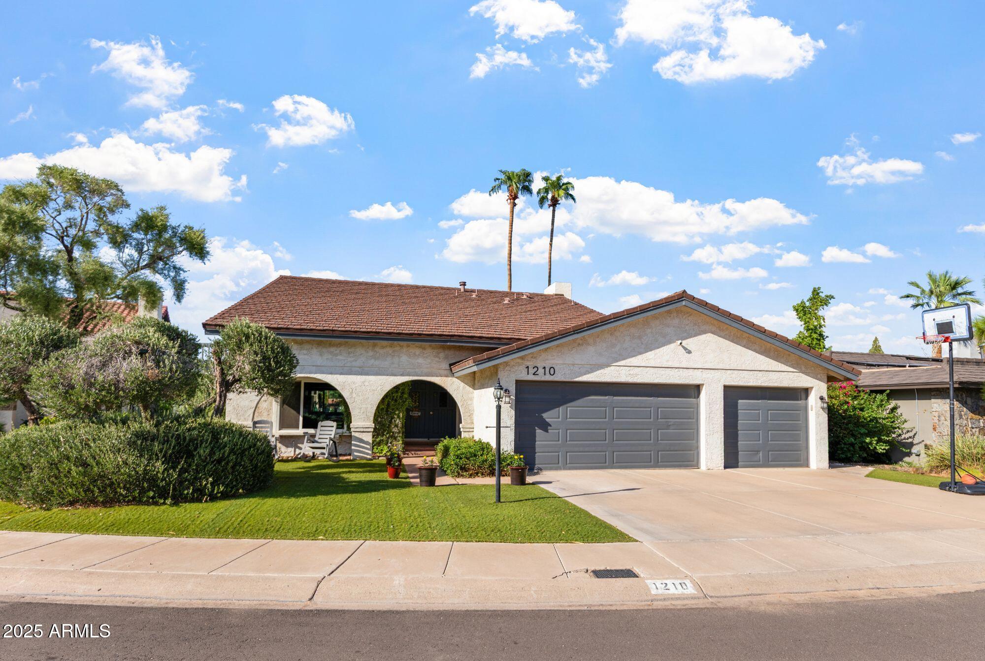 1210 East Harbor View Drive Tempe, AZ 85283 - Photo 8 of 68 a front view of a house with garden