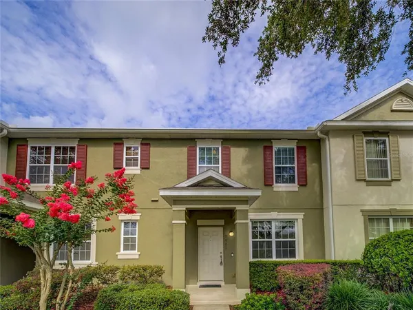 front view of a brick house with a large window