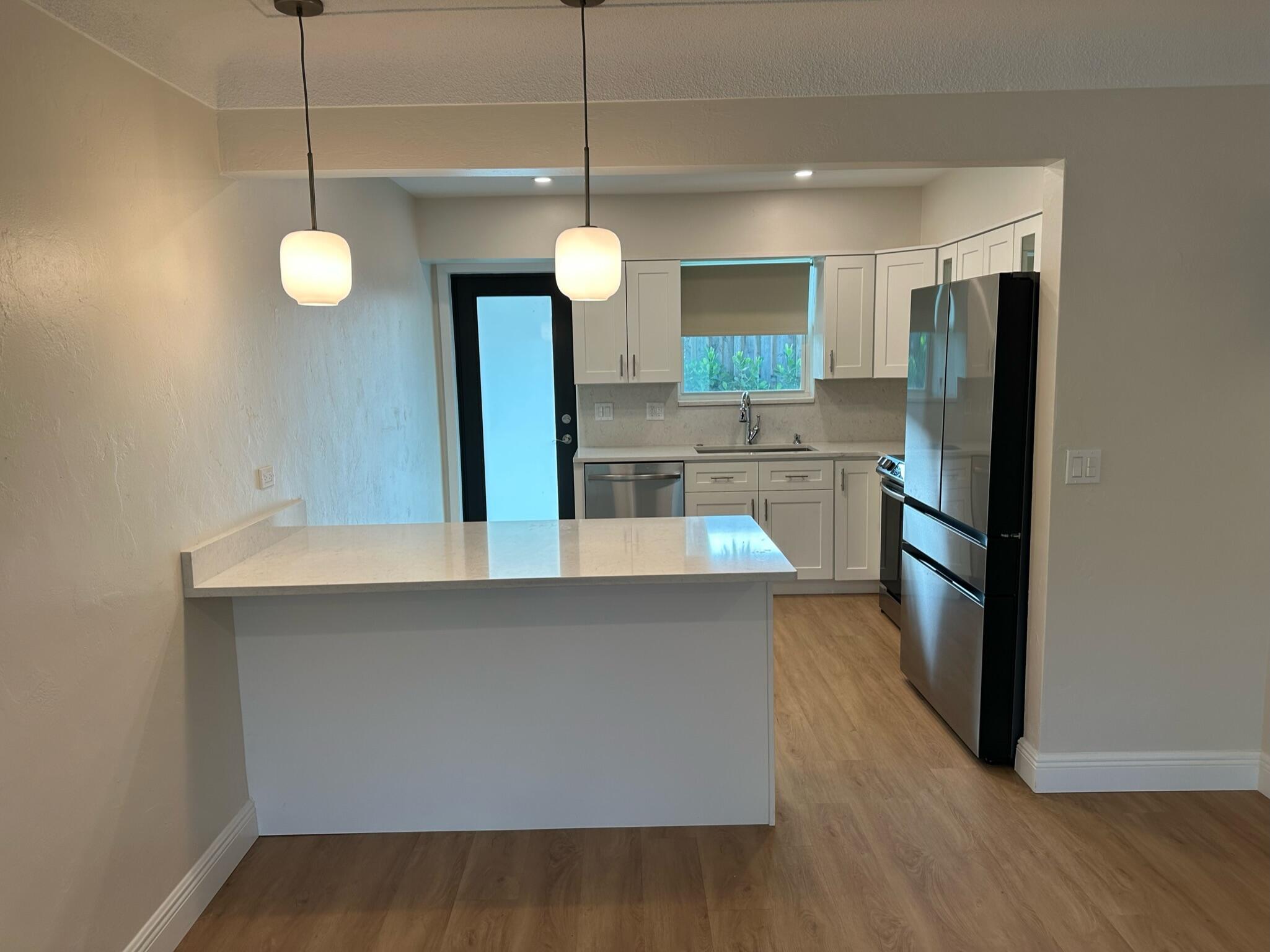 2018 Spanish Trail, Unit 2 Delray Beach, FL 33483 - Photo 1 of 13 a kitchen with stainless steel appliances a refrigerator a sink and a stove