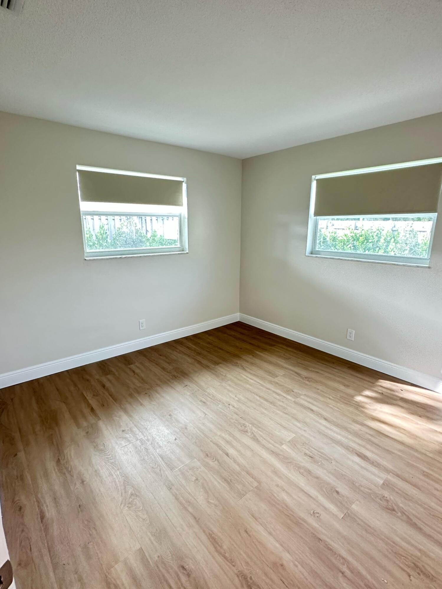 2018 Spanish Trail, Unit 2 Delray Beach, FL 33483 - Photo 11 of 13 an empty room with wooden floor and windows