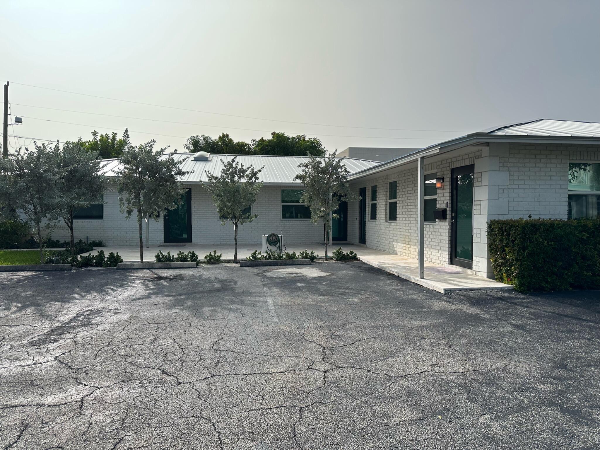 2018 Spanish Trail, Unit 2 Delray Beach, FL 33483 - Photo 3 of 13 a view of a house with a yard and garage
