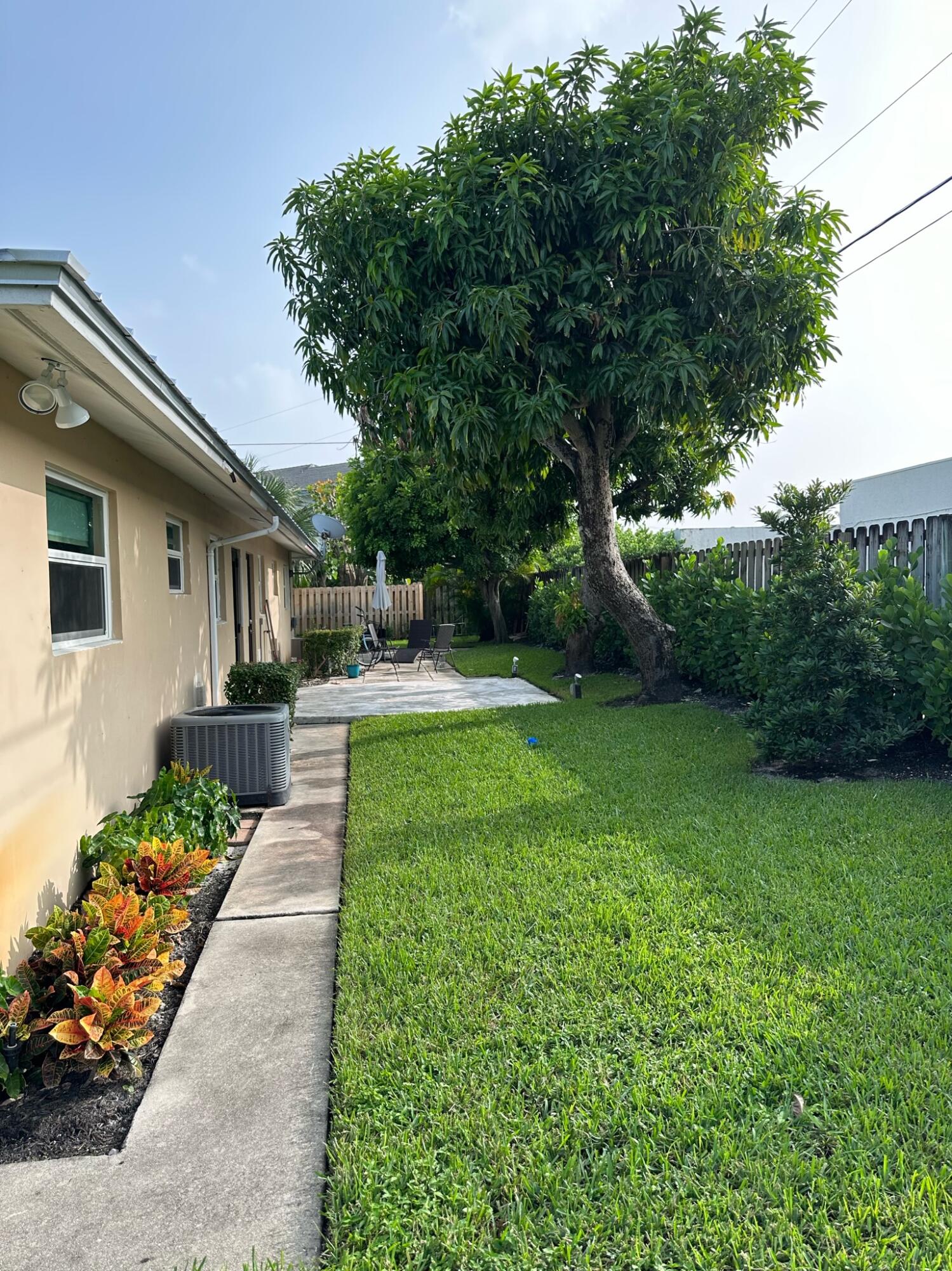 2018 Spanish Trail, Unit 2 Delray Beach, FL 33483 - Photo 4 of 13 a front view of a house with garden