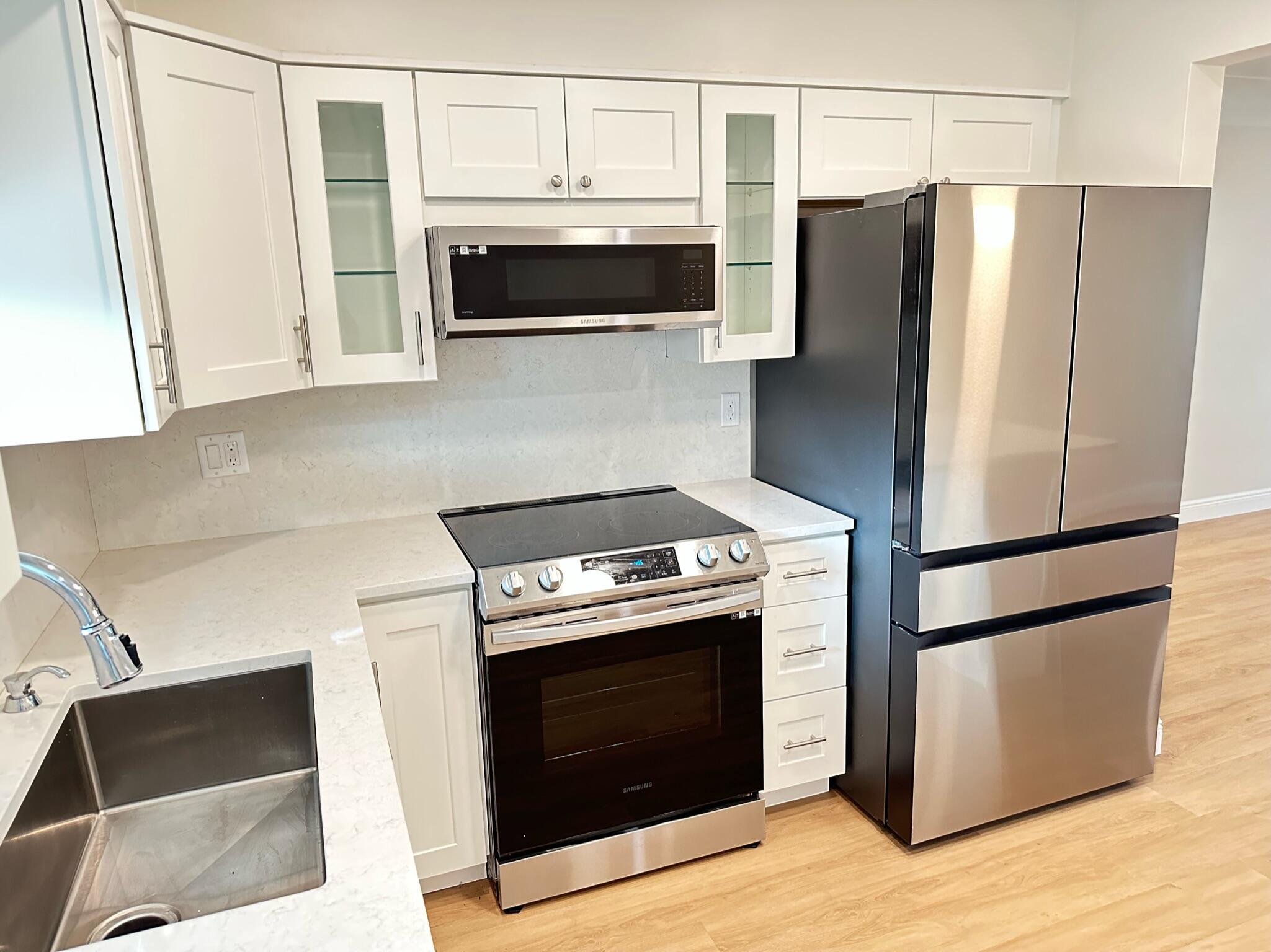 2018 Spanish Trail, Unit 2 Delray Beach, FL 33483 - Photo 8 of 13 a kitchen with stainless steel appliances a stove microwave and refrigerator