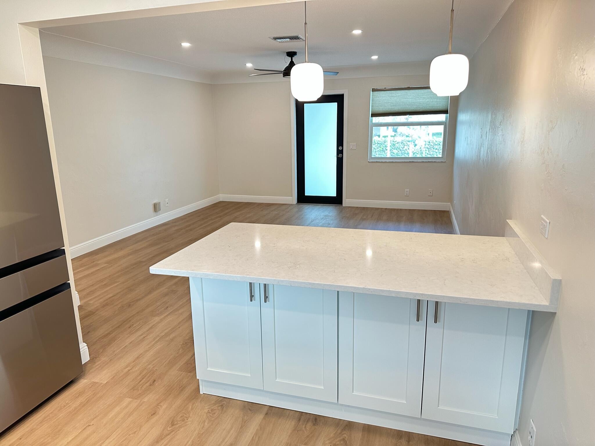 2018 Spanish Trail, Unit 2 Delray Beach, FL 33483 - Photo 9 of 13 a view of an empty room with wooden floor and windows
