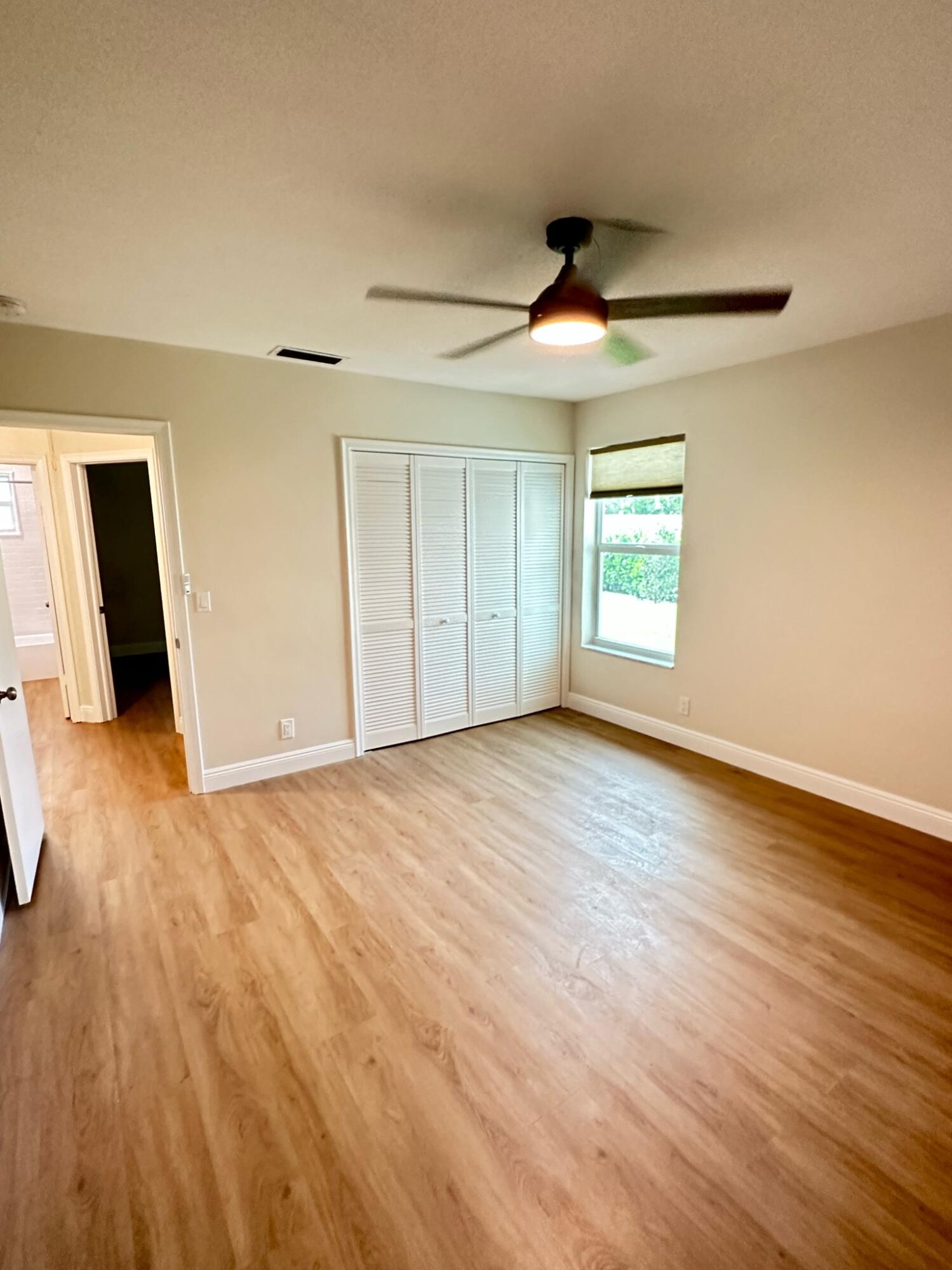 2018 Spanish Trail, Unit 2 Delray Beach, FL 33483 - Photo 10 of 13 an empty room with wooden floor and windows