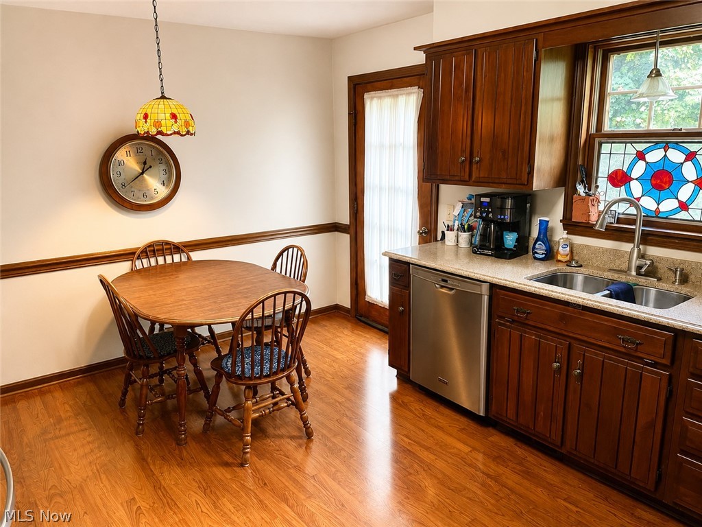 6155 Gibson Road Canfield, OH 44406 - Photo 21 of 43 Kitchen area featuring wood-finish flooring, built-in cabinetry, stone-finish countertops, and a stainless steel dishwasher