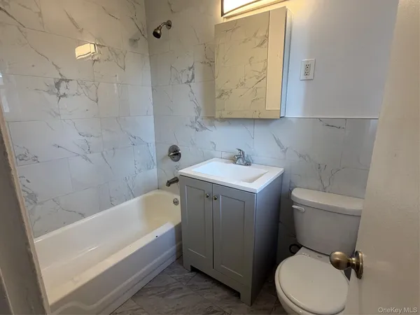 a bathroom with a sink toilet and bathtub
