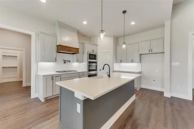 a large kitchen with stainless steel appliances kitchen island a large island in the center