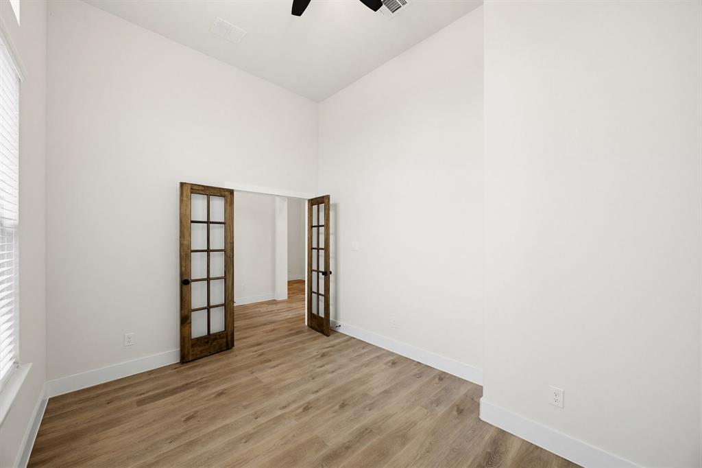 6713 Odom Road Sanger, TX 76266 - Photo 15 of 32 a view of an empty room with wooden floor and a window