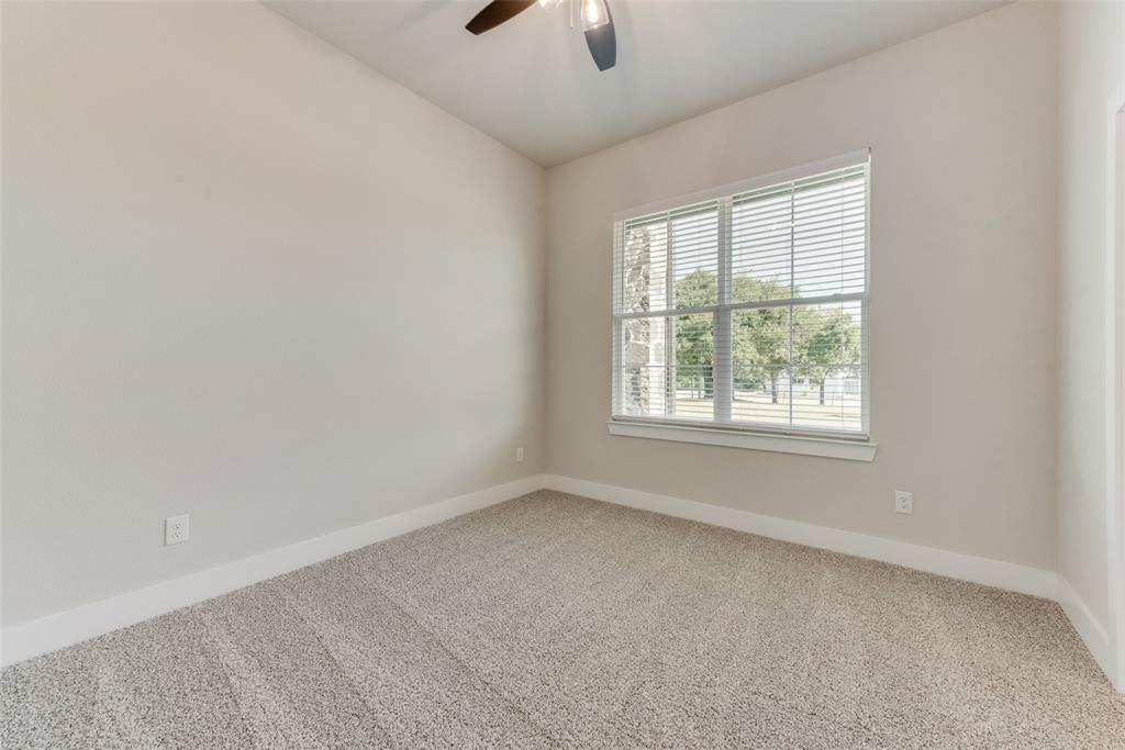 6713 Odom Road Sanger, TX 76266 - Photo 15 of 36 an empty room with a window and a ceiling fan