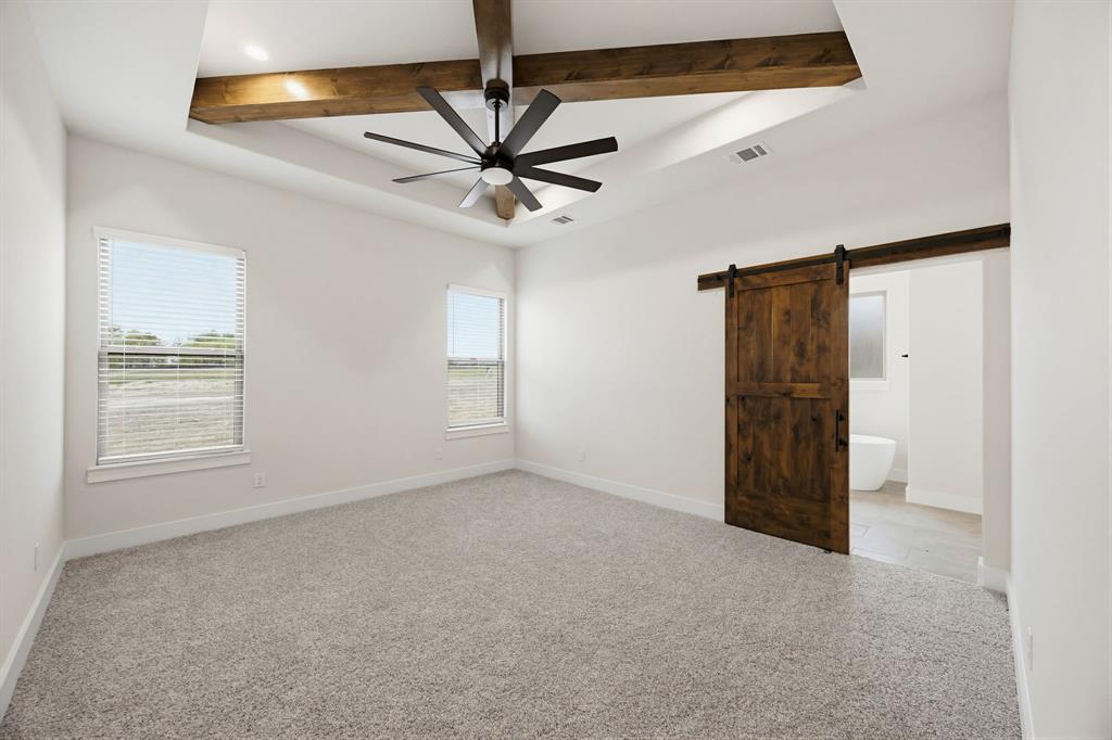 6713 Odom Road Sanger, TX 76266 - Photo 16 of 32 an empty room with closet and a chandelier fan