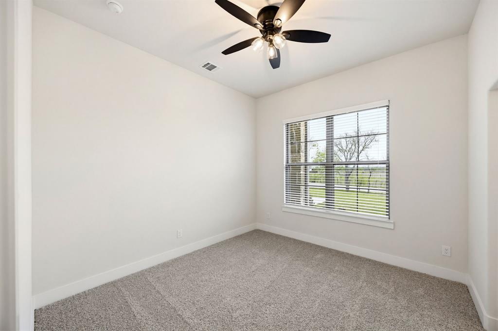 6713 Odom Road Sanger, TX 76266 - Photo 17 of 32 an empty room with windows and fan