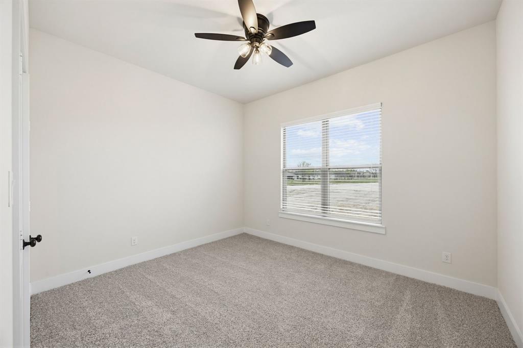 6713 Odom Road Sanger, TX 76266 - Photo 18 of 32 an empty room with a window and a fan