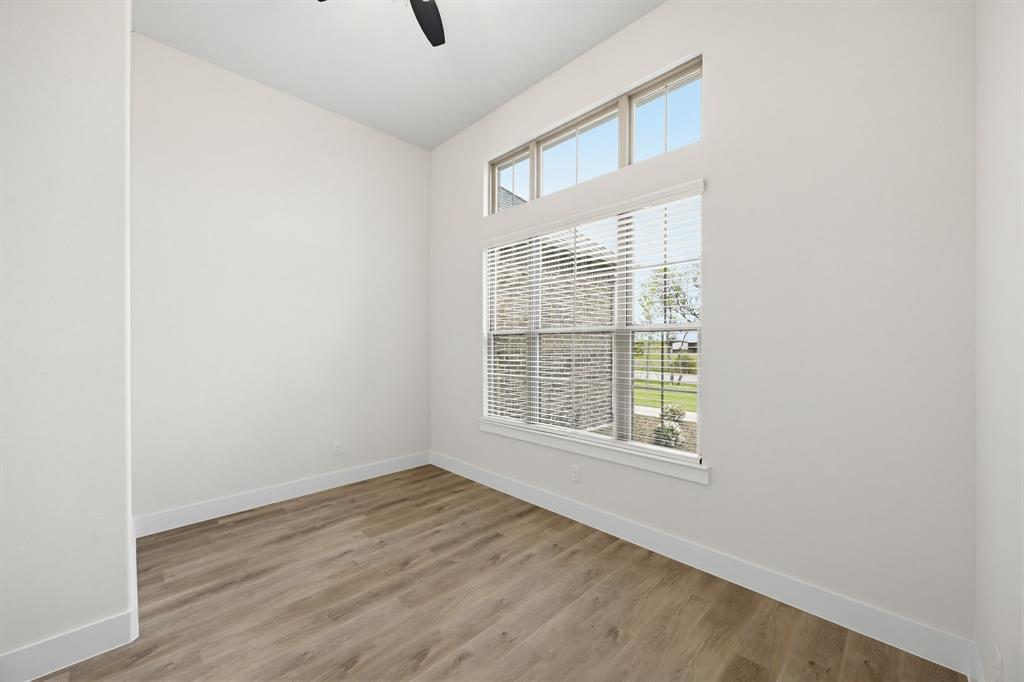 6713 Odom Road Sanger, TX 76266 - Photo 19 of 32 an empty room with wooden floor and windows
