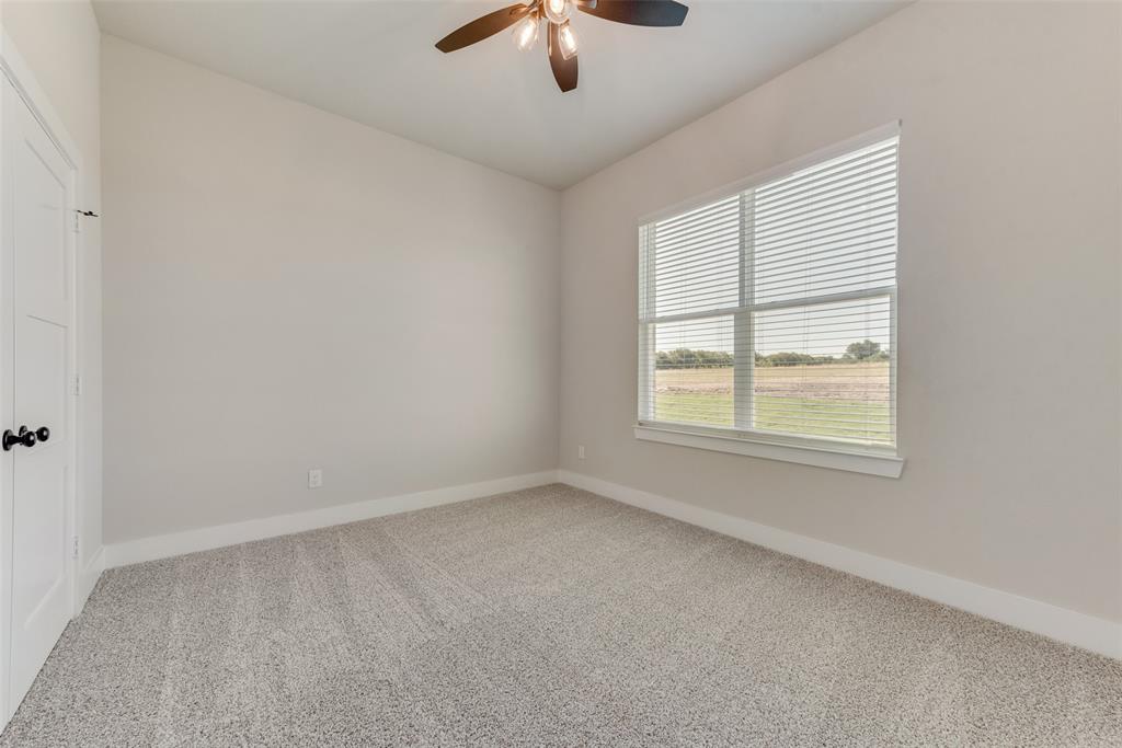 6713 Odom Road Sanger, TX 76266 - Photo 22 of 36 an empty room with a window and a ceiling fan