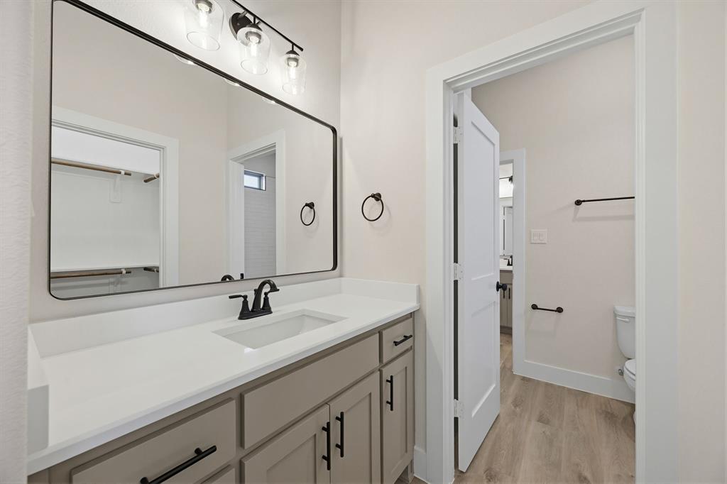 6713 Odom Road Sanger, TX 76266 - Photo 22 of 32 a bathroom with a sink and a mirror