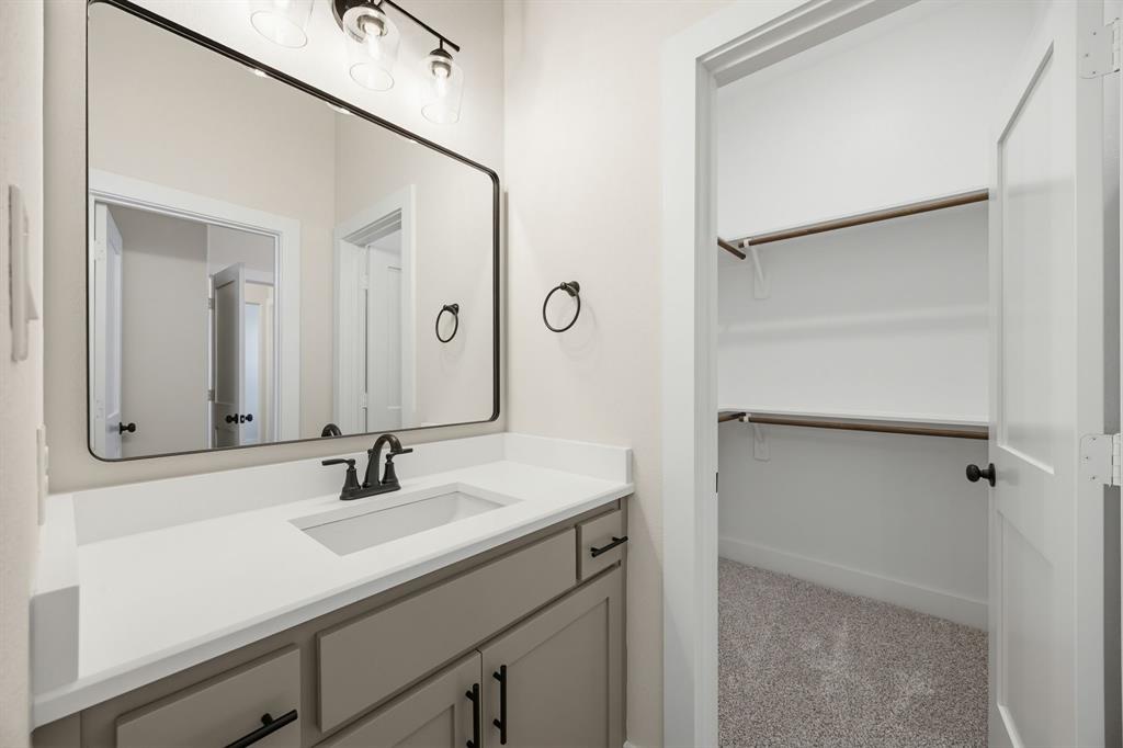 6713 Odom Road Sanger, TX 76266 - Photo 26 of 32 a bathroom with a sink and a mirror