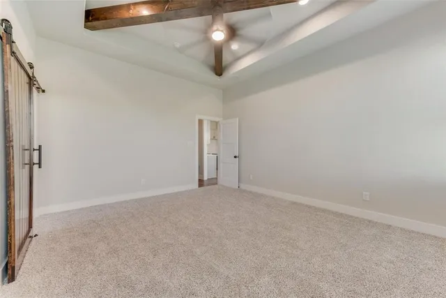 an empty room with a ceiling fan and window