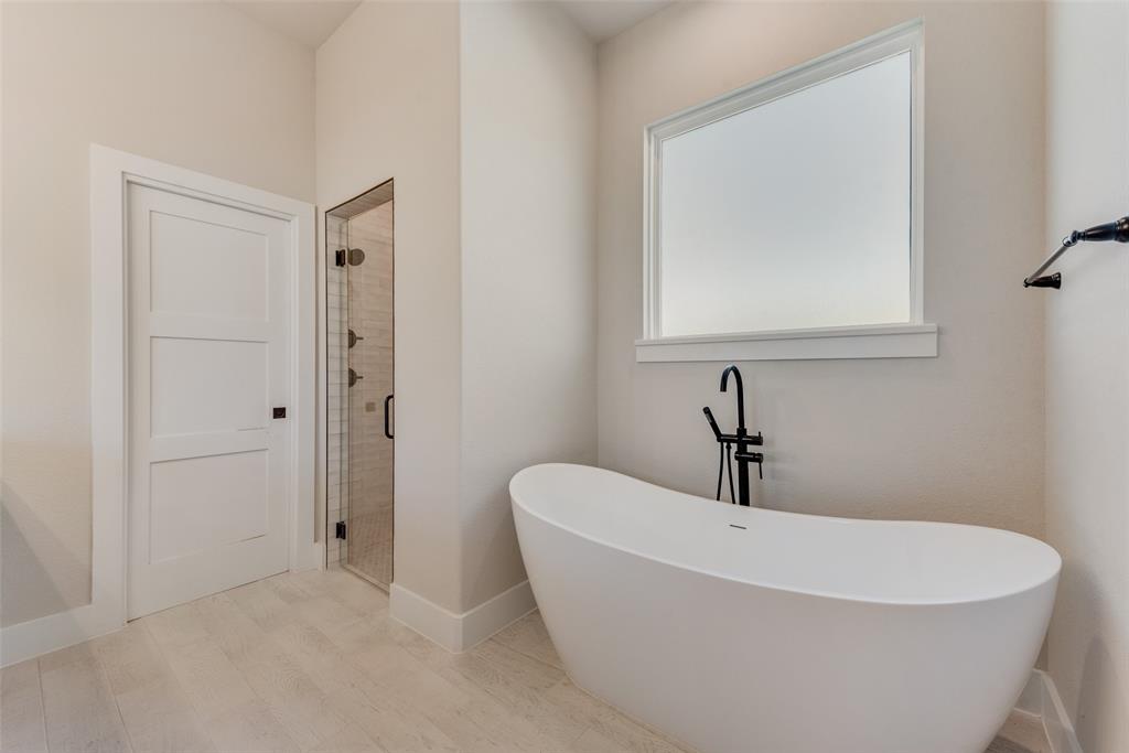 6713 Odom Road Sanger, TX 76266 - Photo 28 of 36 a white bath tub sitting in a bathroom