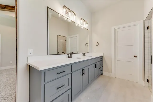 a bathroom with a double vanity sink mirror and