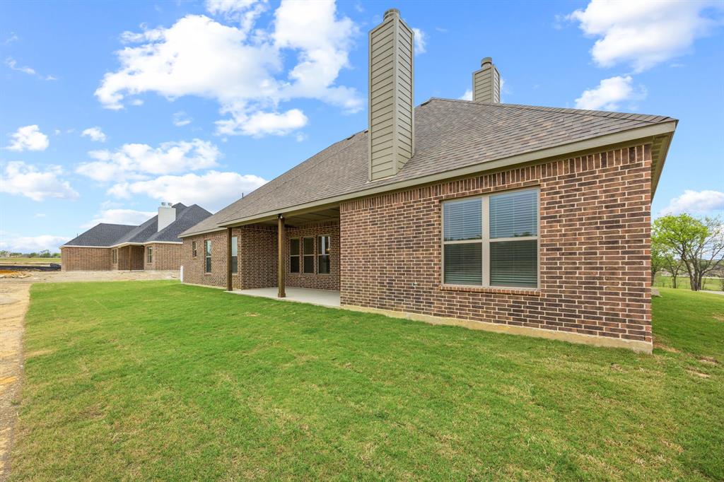 6713 Odom Road Sanger, TX 76266 - Photo 30 of 32 a front view of a house with a garden