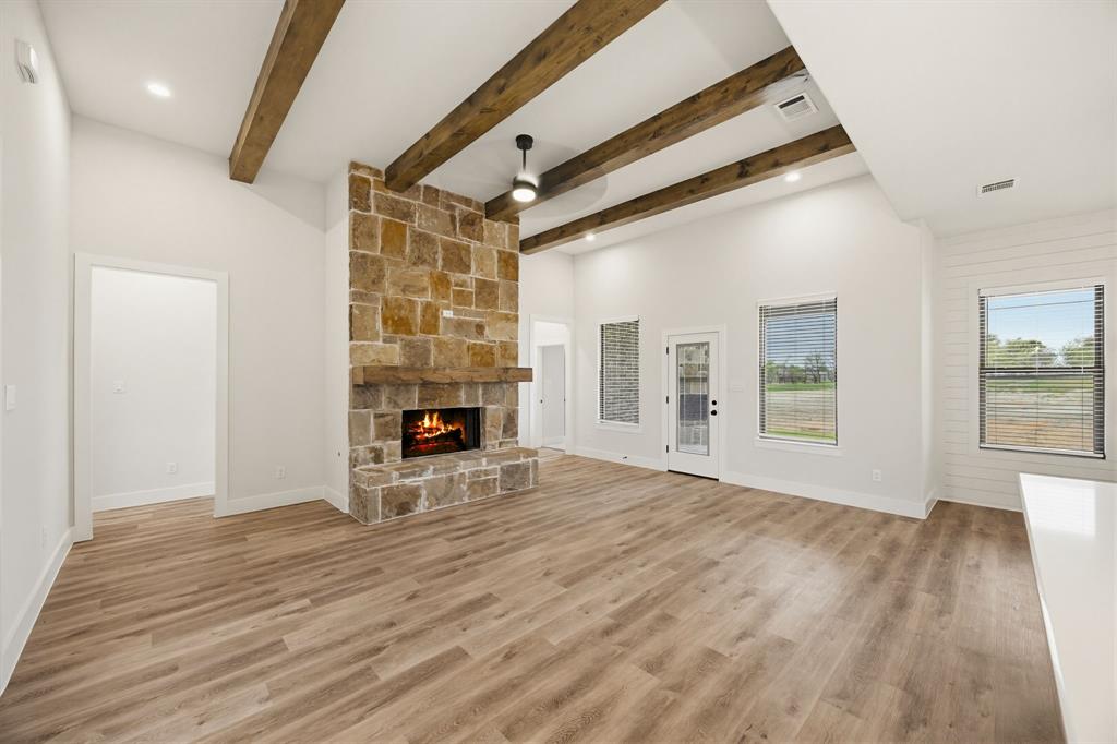 6713 Odom Road Sanger, TX 76266 - Photo 3 of 32 a view of empty room with wooden floor and fireplace