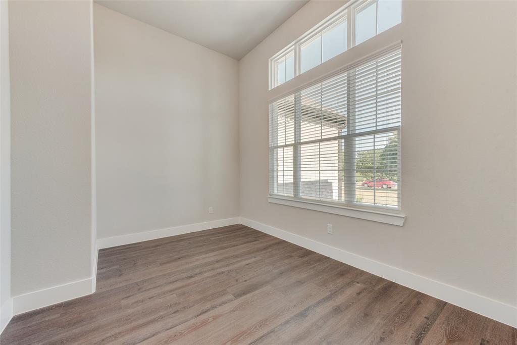 6713 Odom Road Sanger, TX 76266 - Photo 7 of 36 an empty room with wooden floor and windows