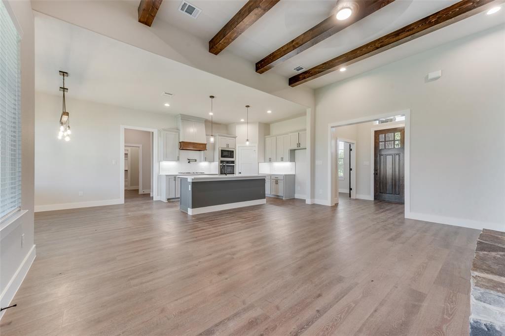 6713 Odom Road Sanger, TX 76266 - Photo 10 of 36 a view of a kitchen with a sink and a refrigerator