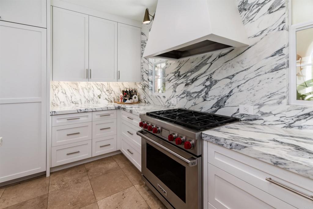 2367 Lapis Road Carlsbad, CA 92009 - Photo 15 of 58 a kitchen with granite countertop a stove and a sink
