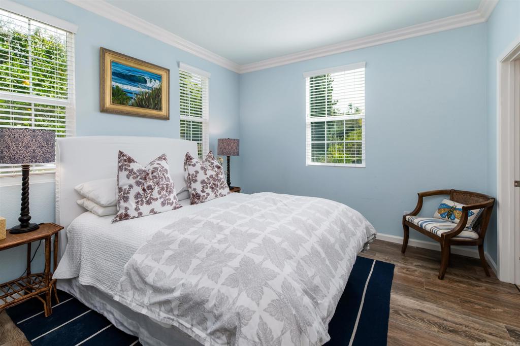 2367 Lapis Road Carlsbad, CA 92009 - Photo 22 of 58 a bedroom with a bed and a chair
