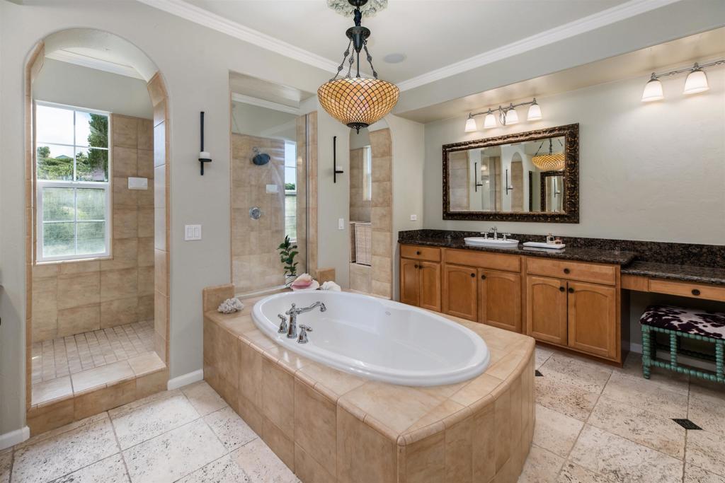 2367 Lapis Road Carlsbad, CA 92009 - Photo 29 of 58 a spacious bathroom with a sink a mirror a window and a bathtub