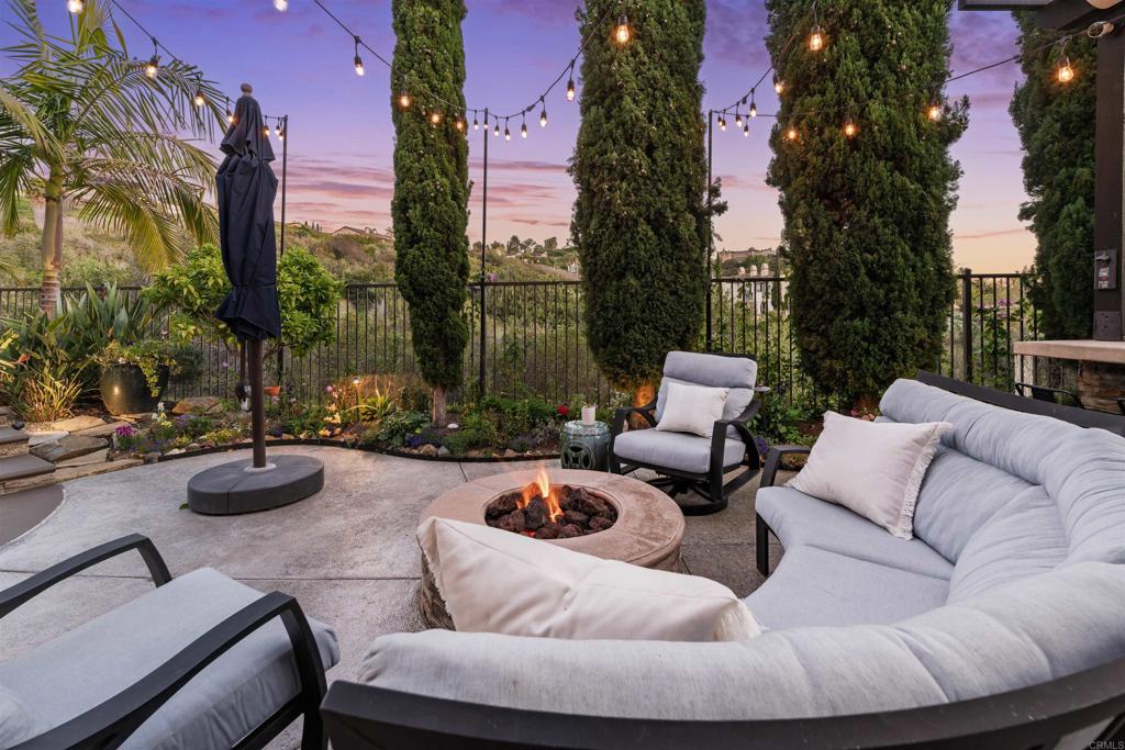 2367 Lapis Road Carlsbad, CA 92009 - Photo 40 of 58 a view of a patio with couches and a fire pit and a fire pit