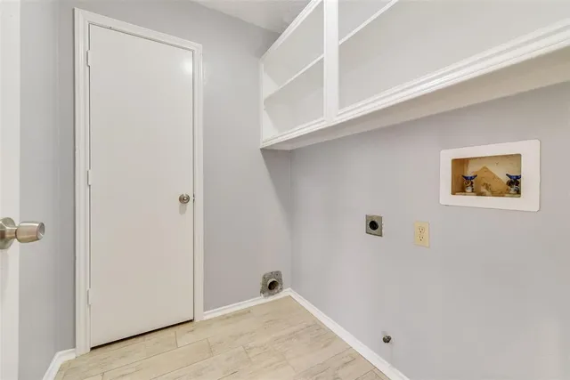 an empty room with wooden floor ceiling fan and windows