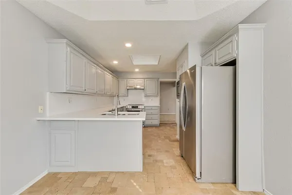 a kitchen with stainless steel appliances granite countertop a sink and cabinets