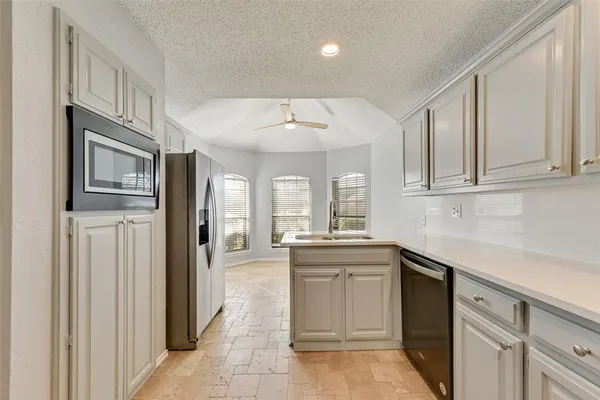 a kitchen with stainless steel appliances granite countertop a stove and a sink