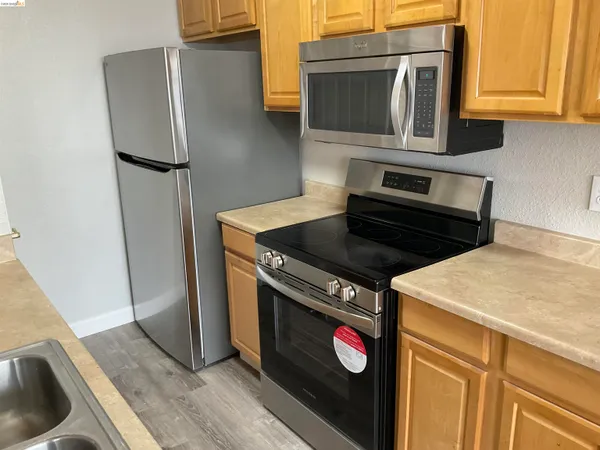 a kitchen with granite countertop a stove and a refrigerator