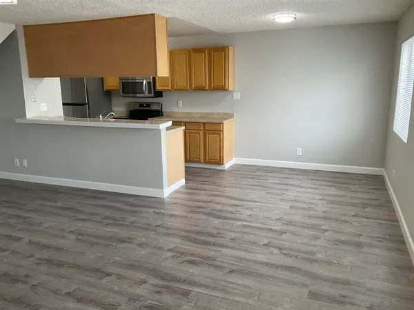 a view of a kitchen with a sink and a stove top oven