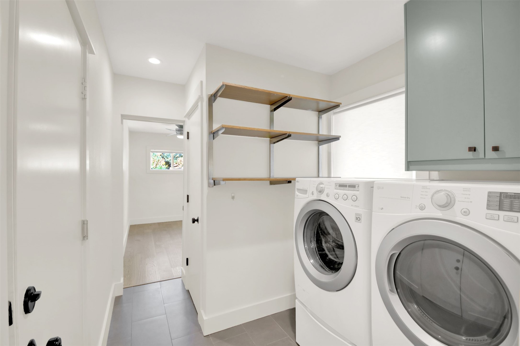 7510 Daugherty Street Austin, TX 78757 - Photo 11 of 37 Laundry room featuring separate washer and dryer, light tile patterned floors, cabinet space, ceiling fan, and recessed lighting