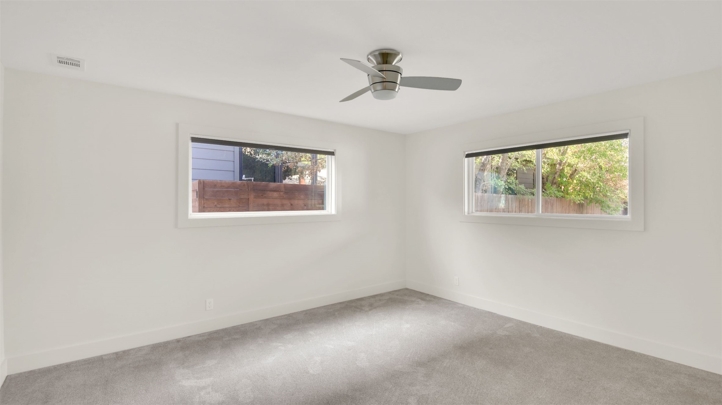 7510 Daugherty Street Austin, TX 78757 - Photo 15 of 37 Carpeted spare room featuring healthy amount of natural light and ceiling fan