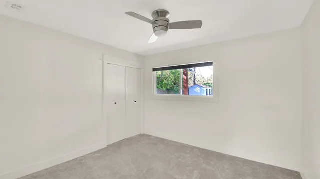 a view of living room with granite countertop furniture and floor to ceiling window