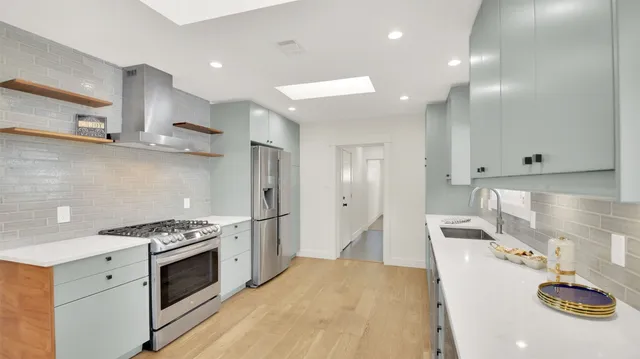 an empty room with a ceiling fan and a window