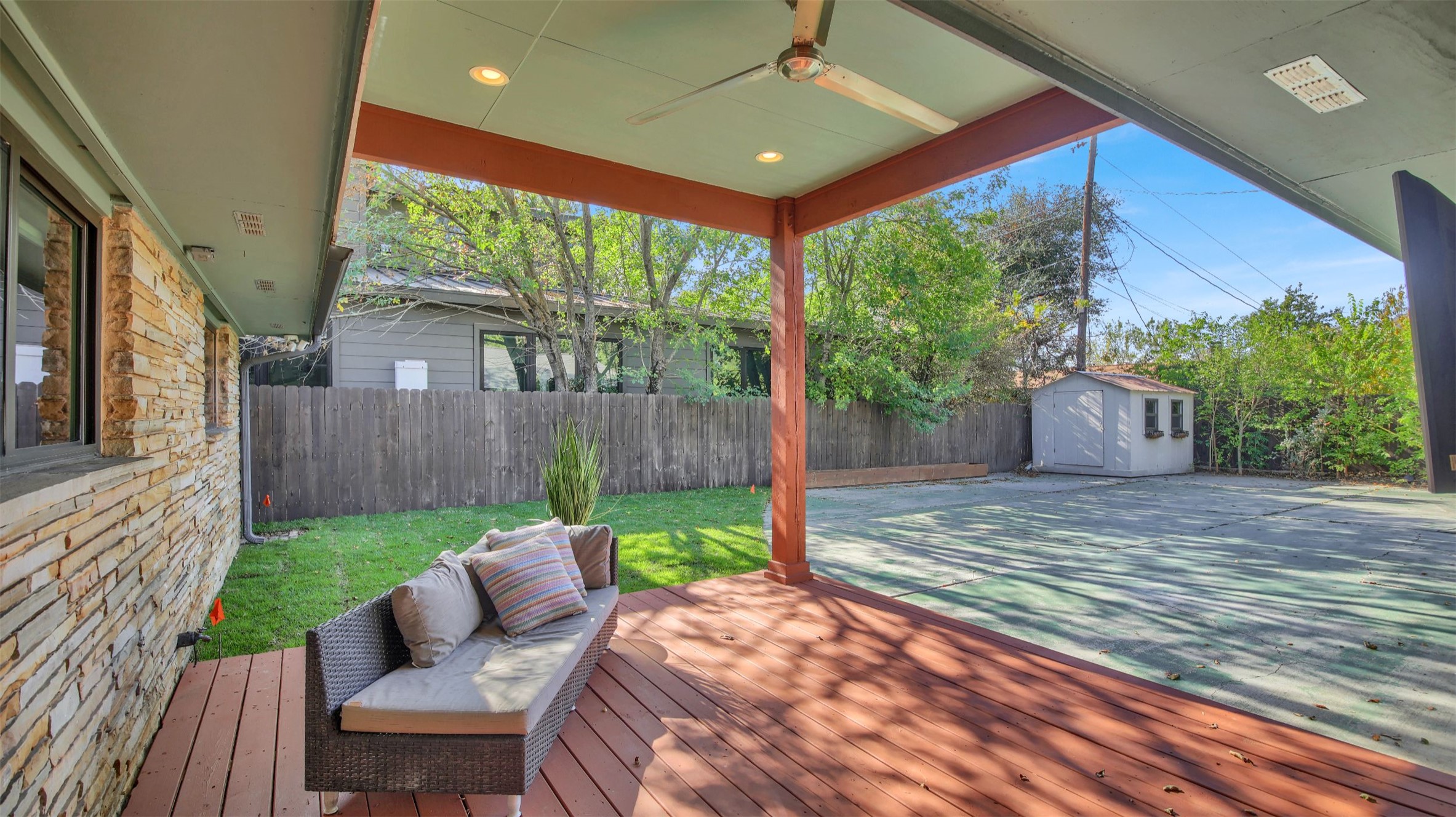 7510 Daugherty Street Austin, TX 78757 - Photo 18 of 37 Wooden terrace featuring a shed and a fenced backyard
